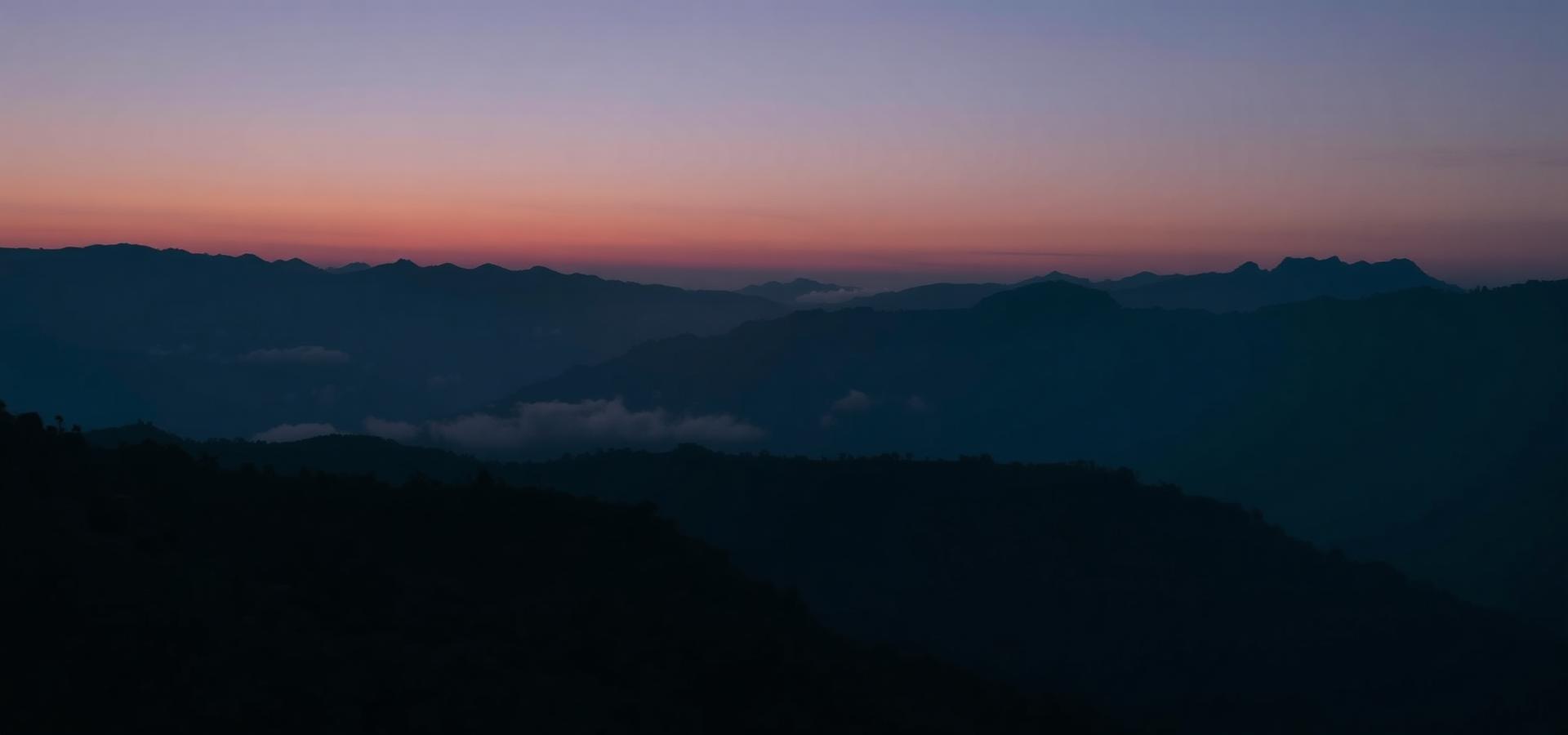 Layered Himalayan ridges at dusk near Arosia Hotels