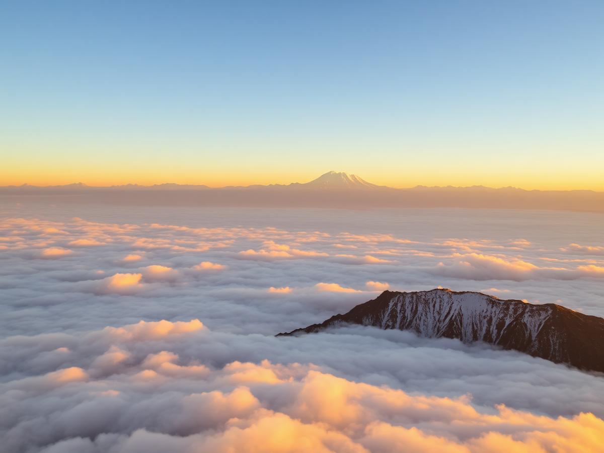 Sunrise light on Himalayan peaks above clouds